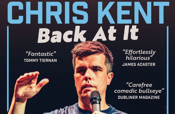 Photo of comedian Chris Kent performing on stage.